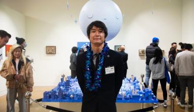 yoskay yamamoto in front of his art
